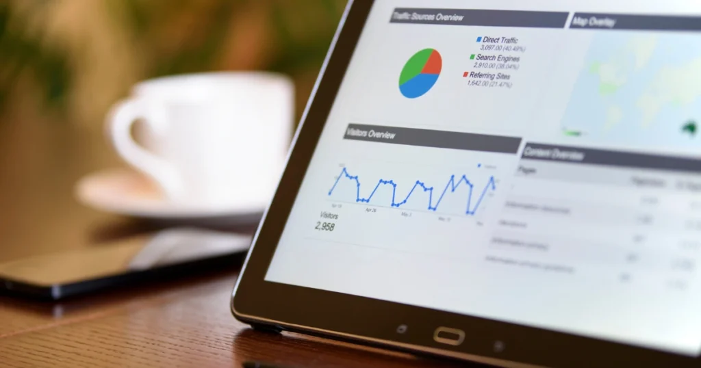 Tablet screen showing website analytics charts and graphs for SEO and Google ranking performance.